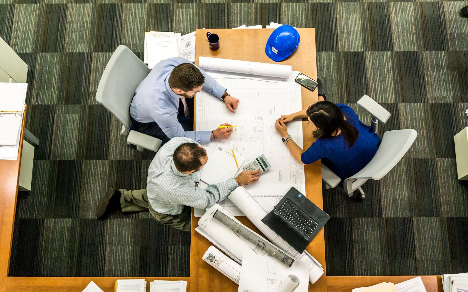 Three People Sitting Beside Table<br />
